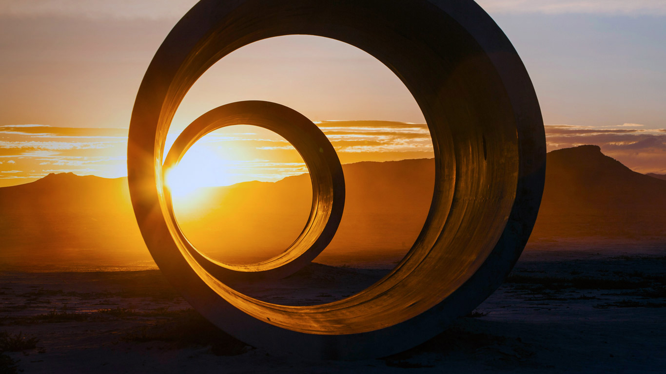 Two rings of earth silhouetted against the sunset