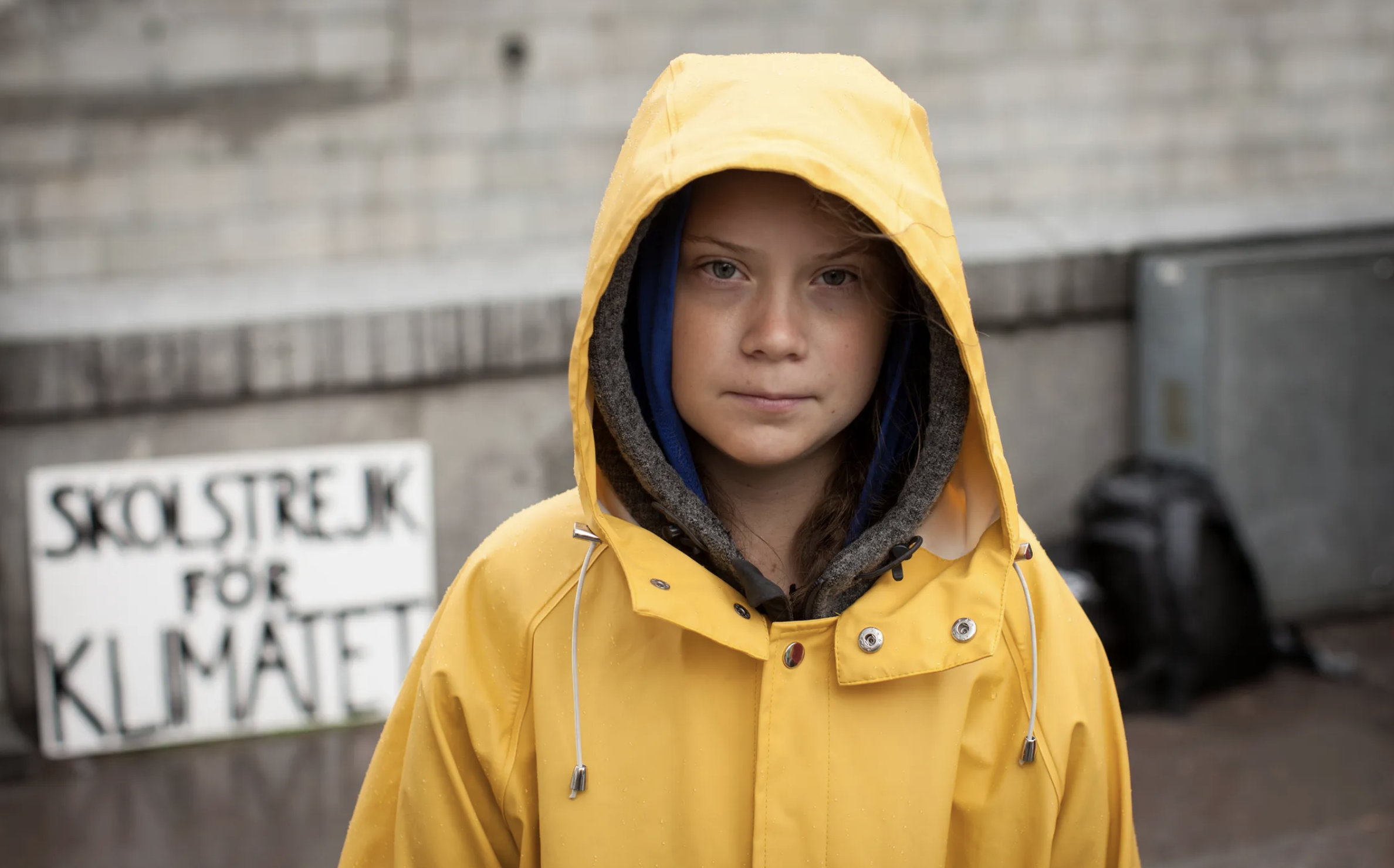 Greta Thunberg wearing a yellow raincoat