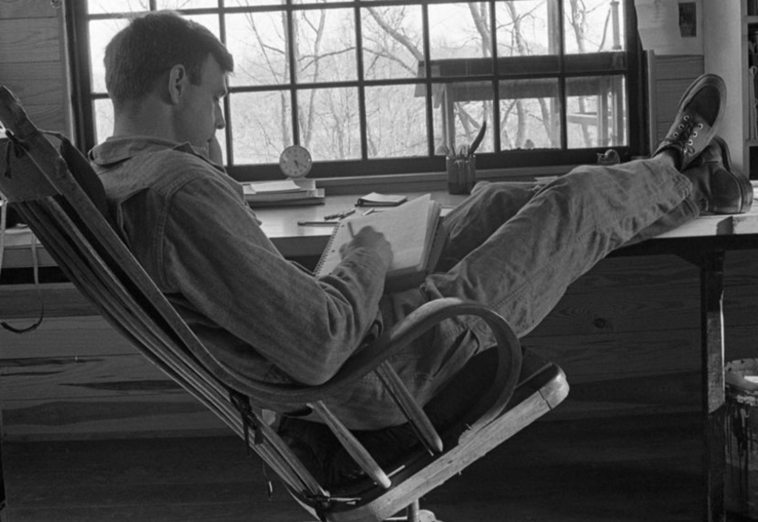 A black-and-white photo of Paul Shepard reclined in a rocking chair