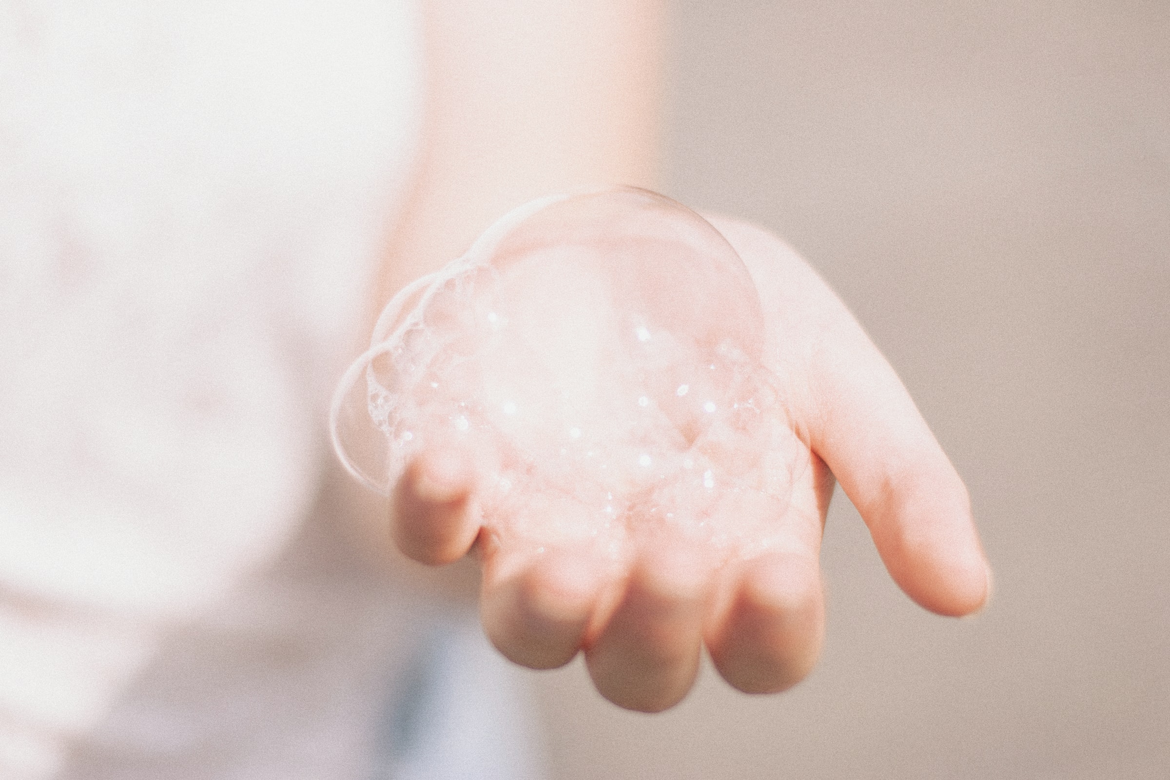 A bubble in someone's outstretched hand