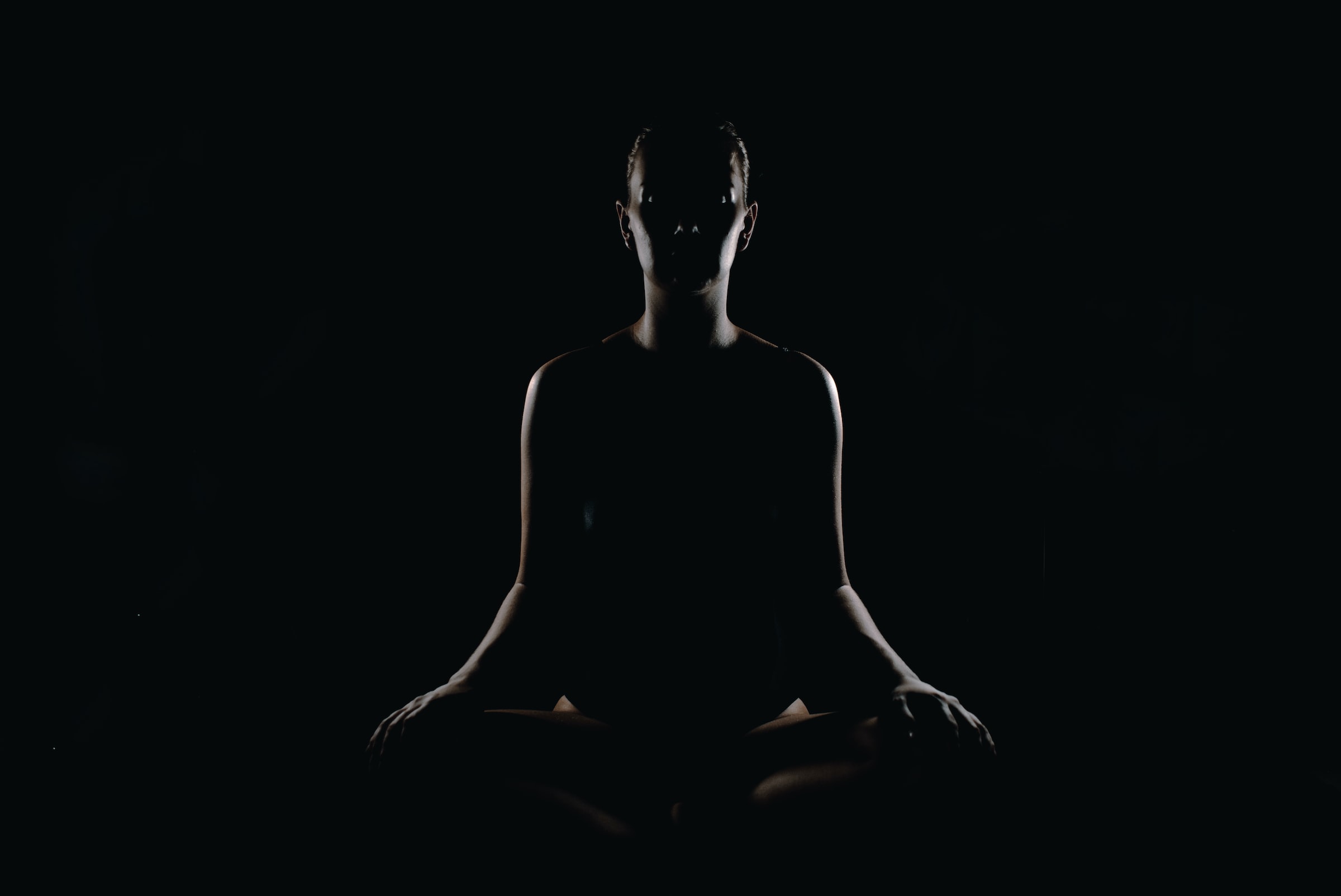 A person sits in a meditative pose