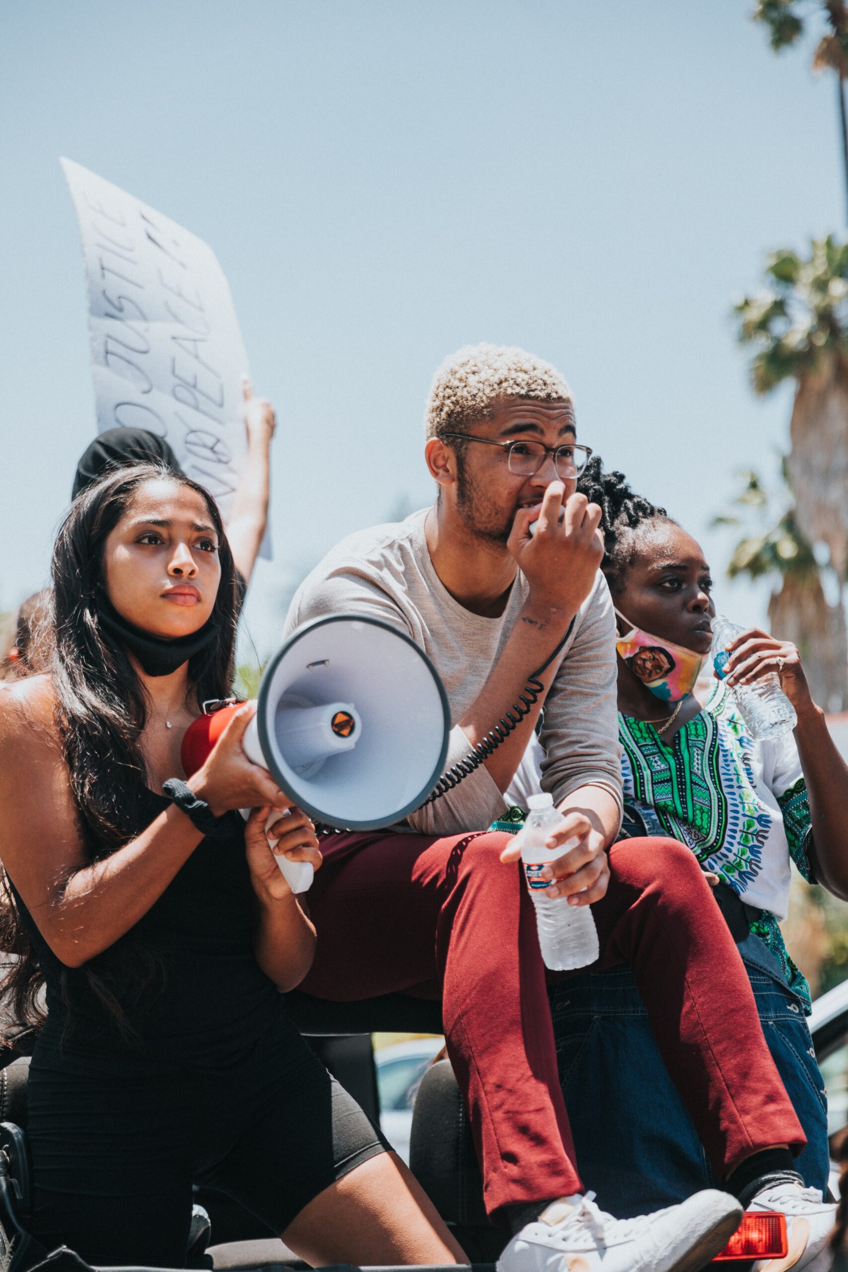 A group of young people use a megaphone