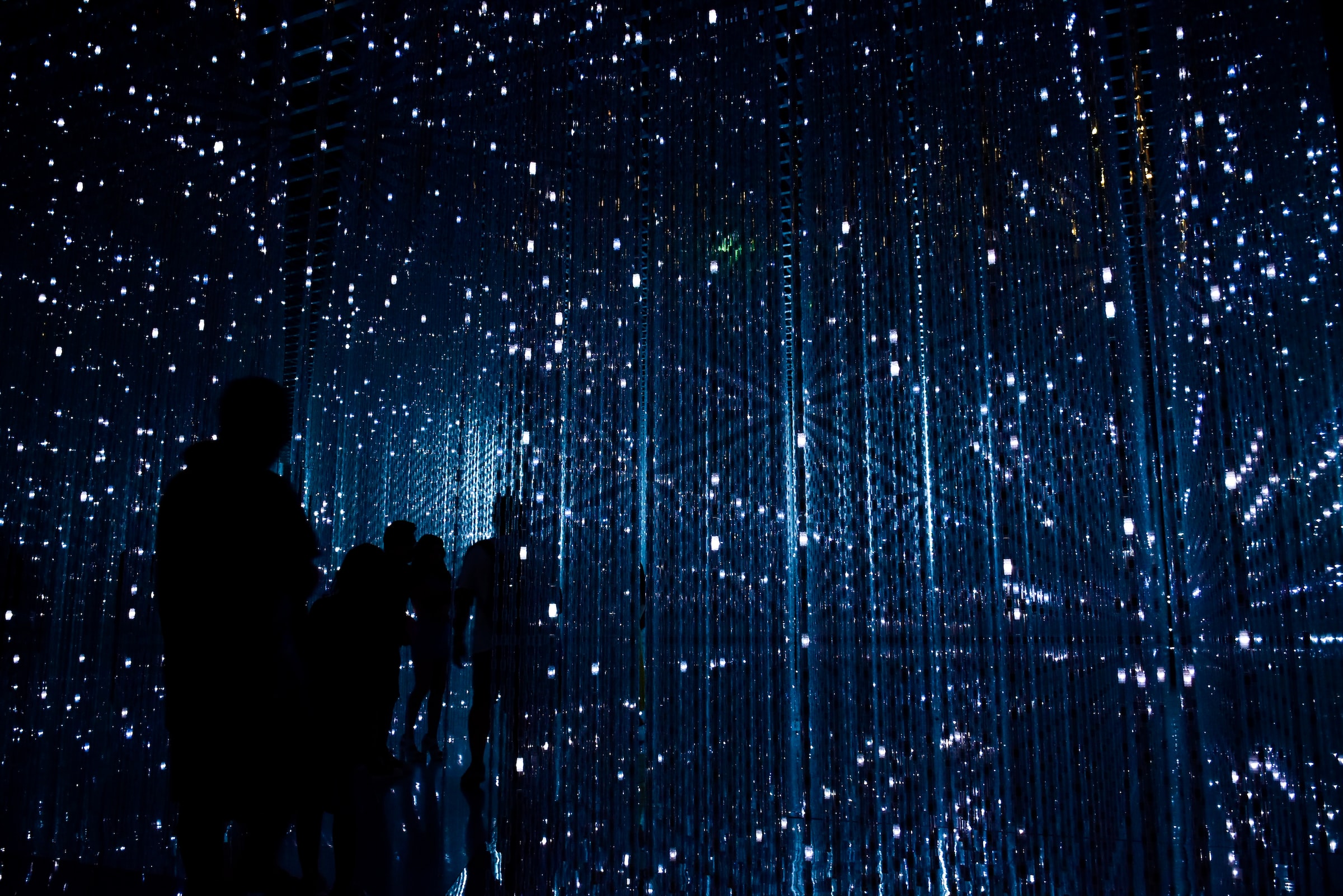A 3-dimensional grid of lights against a blue-black background