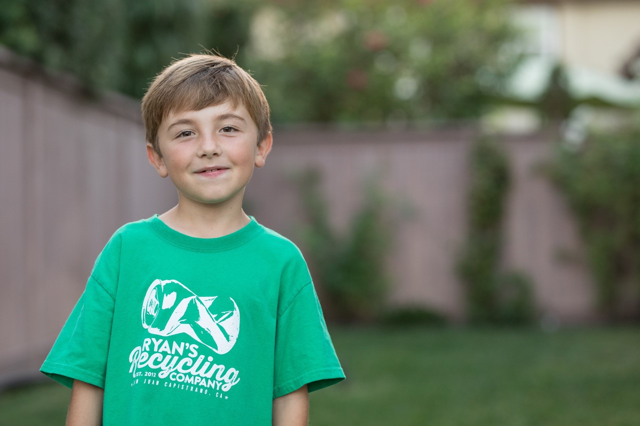 Ryan Hickman wearing a green shirt that reads "Ryan's Recycling Company"