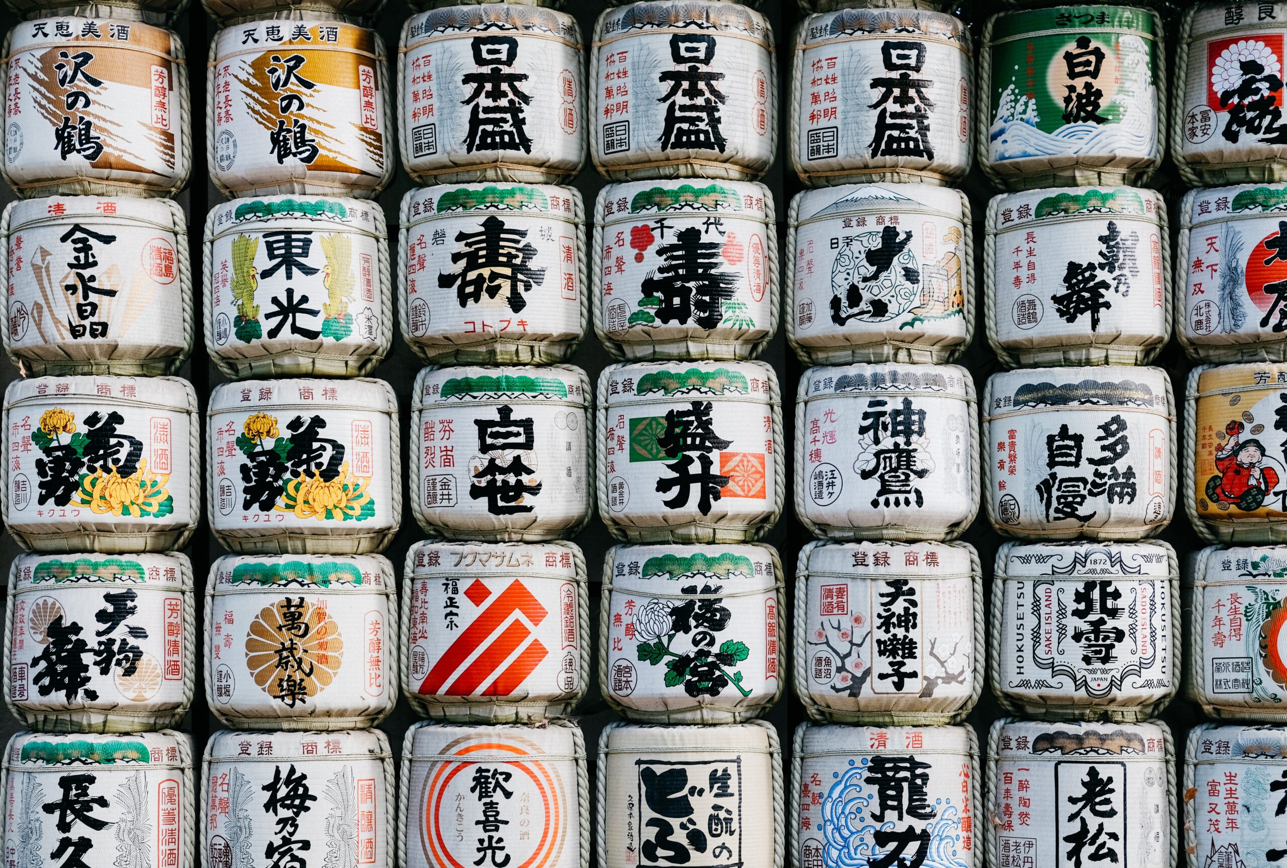 Photograph of large rice basket containers stacked up in a wall-like fashion.